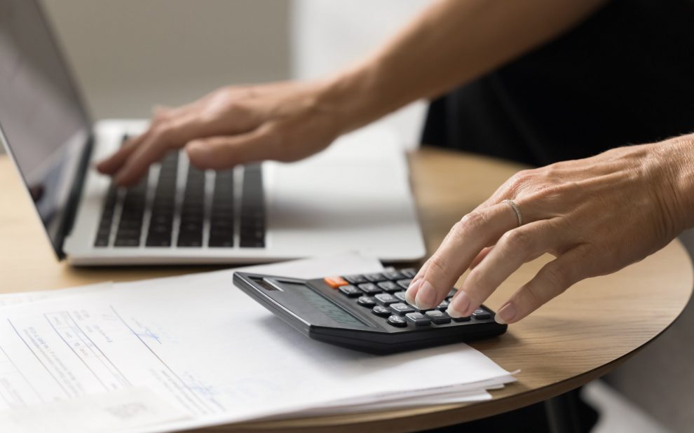 Hands,Of,Senior,Elder,Woman,Using,Laptop,And,Calculator,For